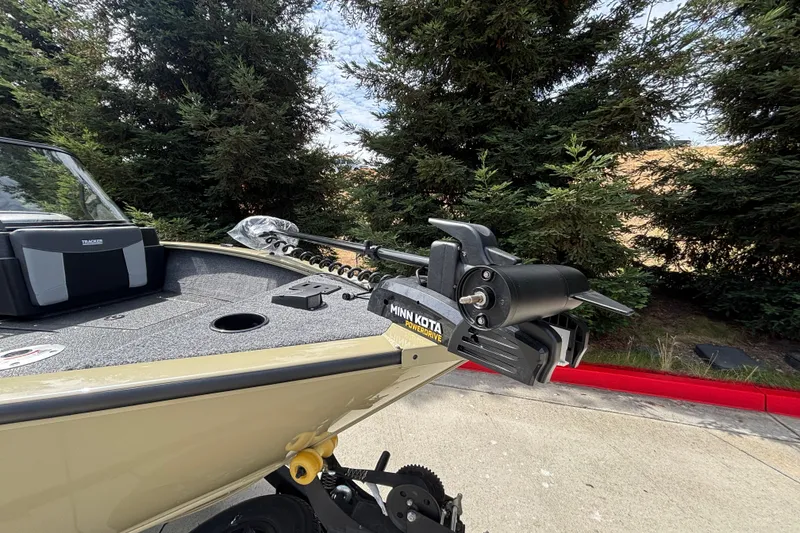 Slide: The Image of 2027 Tracker Pro Guide V-175 Combo boat with Minn Kota PowerDrive motor, parked outdoors. - 34
