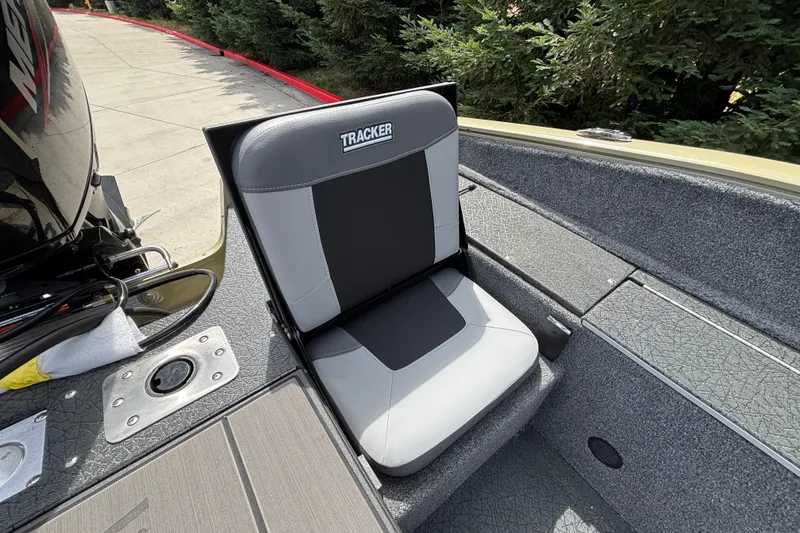 Slide: The Image of 2027 Tracker Pro Guide V-175 Combo boat seat, gray and black design, outdoor setting. - 28