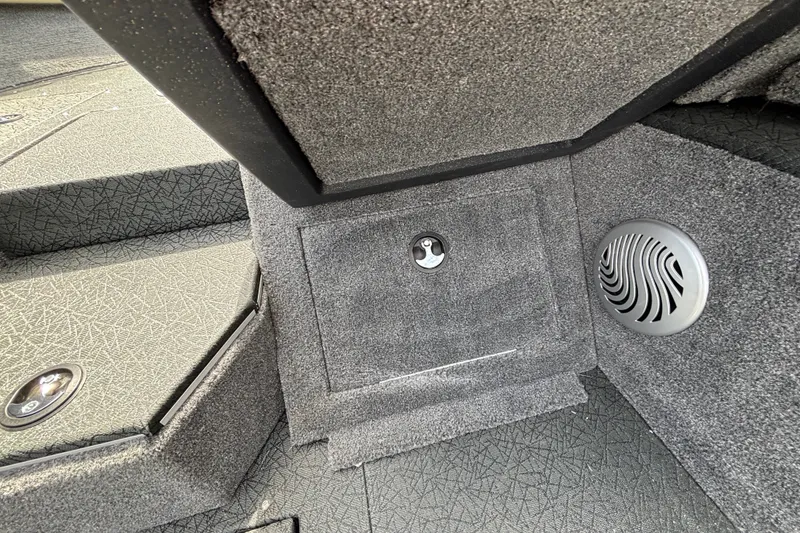 Slide: The Image of Interior of 2027 Tracker Pro Guide V-175 Combo boat, featuring carpeted storage and speaker. - 54