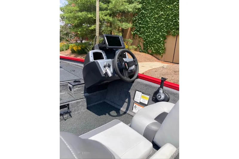 Slide: The Image of 2027 Tracker Pro Team 175 boat interior with steering wheel and control panel. - 21