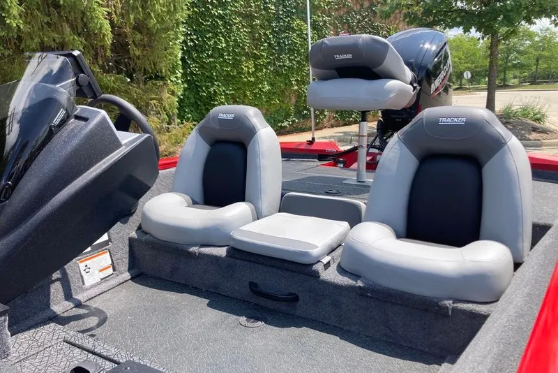 Slide: The Image of 2027 Tracker Pro Team 175 boat interior with gray seating and steering console. - 17