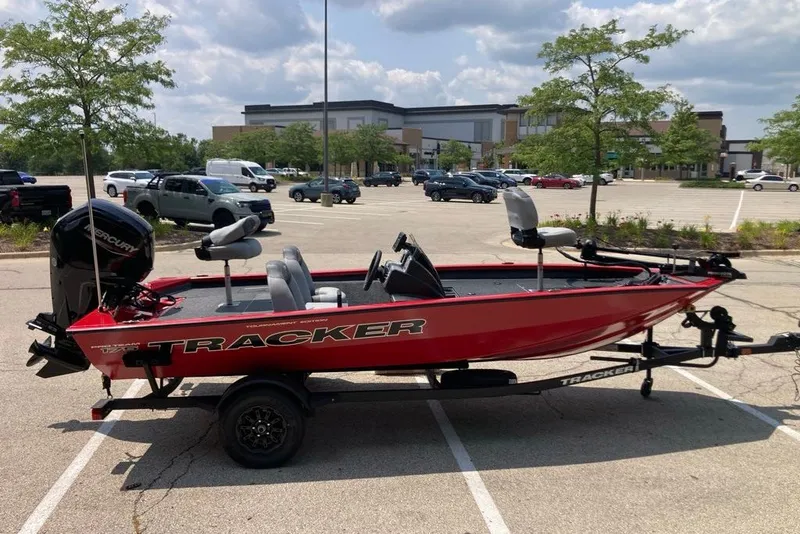 Slide: The Image of Red 2027 Tracker Pro Team 175 boat on trailer in parking lot. - 22