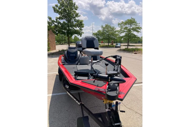 Slide: The Image of 2027 Tracker Pro Team 175 boat in parking lot, red exterior, sunny day. - 14