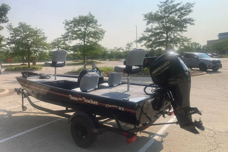 Slide: The Image of 2027 Tracker Pro Team 175 boat with Mercury engine in a parking lot. - 59