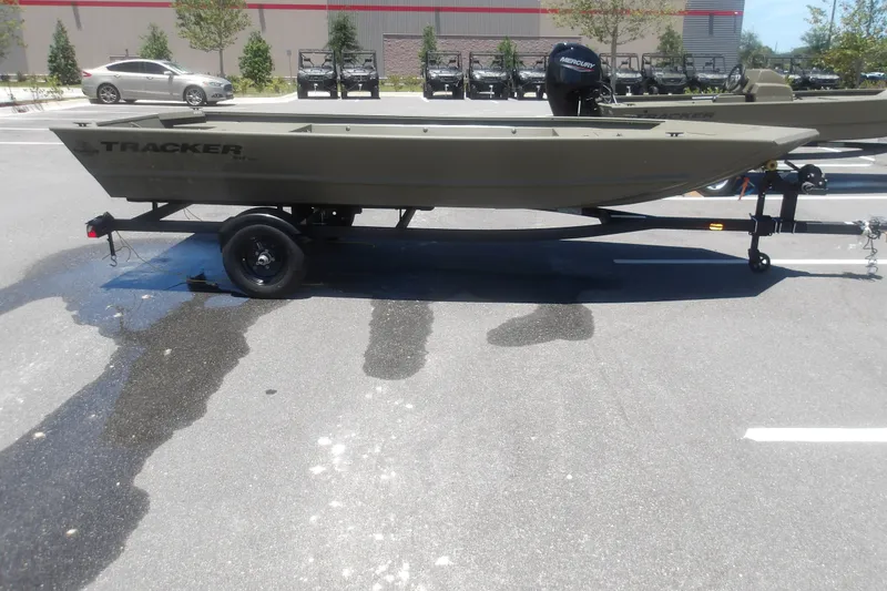 The Image of 2027 Tracker Grizzly 1648 Utility boat on trailer in parking lot. - 0