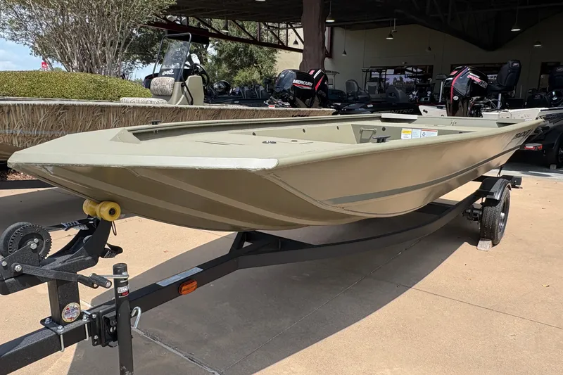 The Image of The image shows a Tracker Grizzly 1648 Utility boat on a trailer, ready for use. - 0