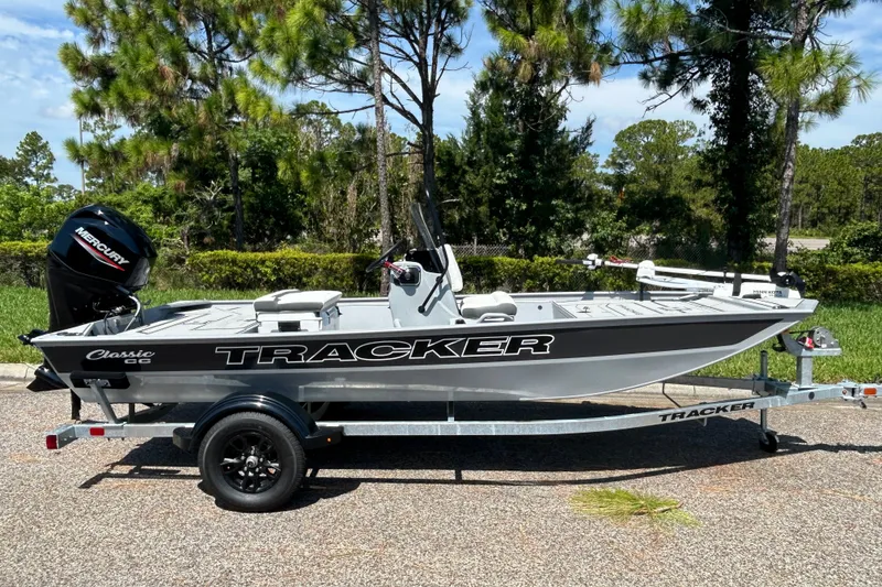The Image of 2027 Tracker Bass Tracker Classic CC boat on trailer, parked outdoors. - 0