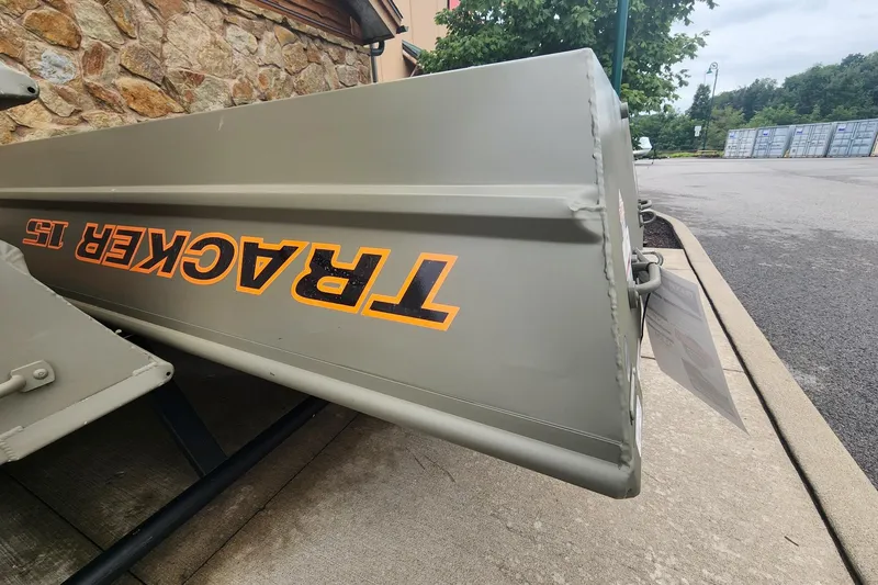 The Image of 2027 Tracker Grizzly 15 Jon boat displayed outdoors on concrete pavement. - 0