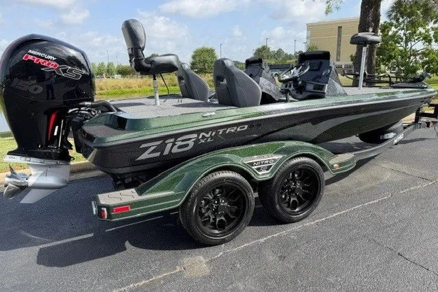 Slide: The Image of 2027 Nitro Z18 XL boat with dual axle trailer, parked outdoors. - 3