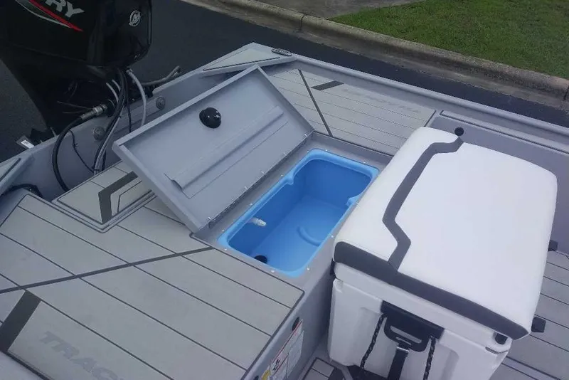 Slide: The Image of 2027 Tracker Bass Tracker Classic CC boat with open storage compartment and cooler. - 13