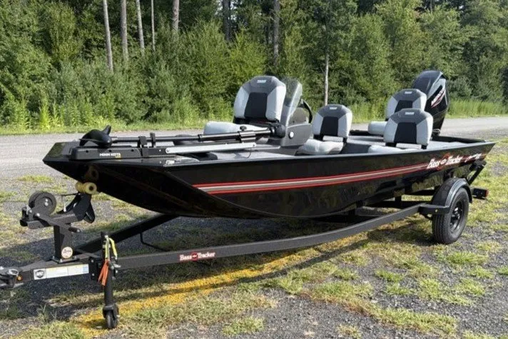The Image of 2027 Tracker Bass Tracker Classic XL boat on trailer, parked outdoors. - 0