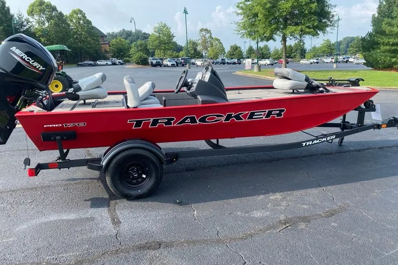 The Image of Red 2027 Tracker Pro 170 boat on trailer in parking lot. - 0
