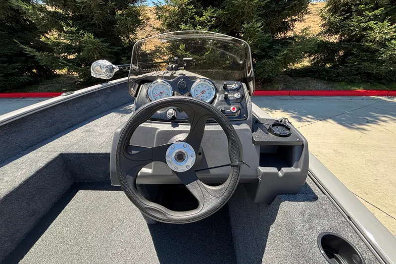 Slide: The Image of Steering console of 2027 Tracker Super Guide V-16 SC boat with gauges and controls. - 16