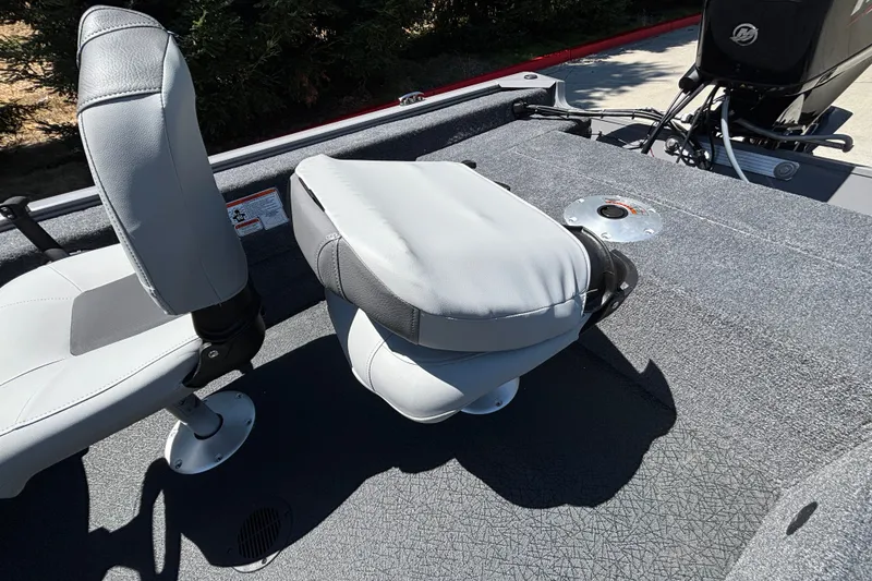 Slide: The Image of 2027 Tracker Super Guide V-16 SC boat interior with gray seating and carpeted deck. - 24