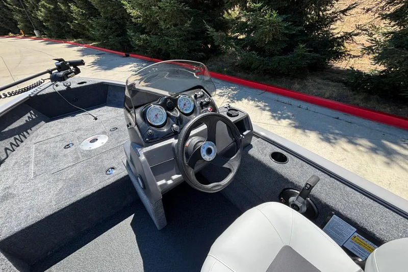 Slide: The Image of 2027 Tracker Super Guide V-16 SC boat interior with steering wheel and dashboard. - 17