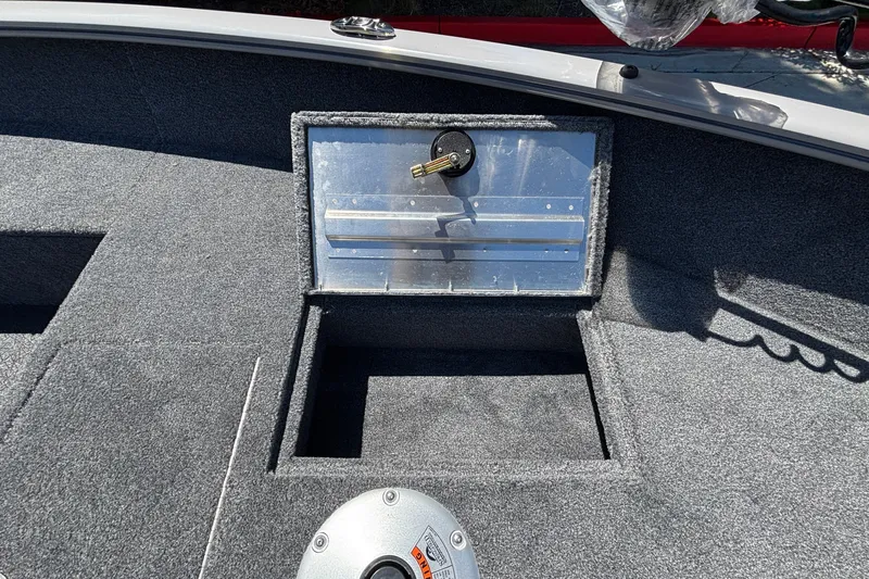 Slide: The Image of 2027 Tracker Super Guide V-16 SC boat interior with storage compartment and key lock. - 27