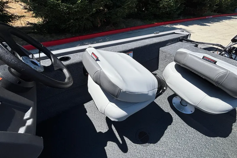 Slide: The Image of 2027 Tracker Super Guide V-16 SC boat interior with steering wheel and seating. - 22