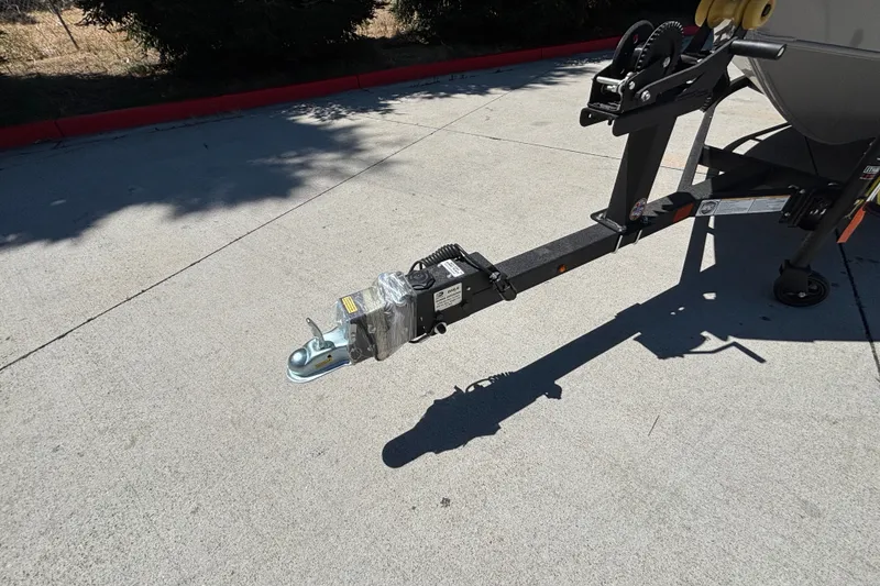 Slide: The Image of Trailer hitch of 2027 Tracker Super Guide V-16 SC on concrete pavement. - 35