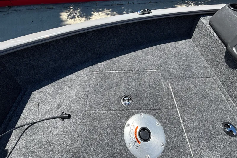 Slide: The Image of Interior of 2027 Tracker Super Guide V-16 SC boat, featuring carpeted flooring and storage compartments. - 29