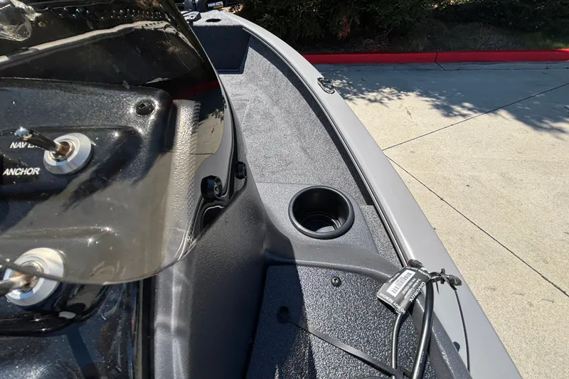 Slide: The Image of 2027 Tracker Super Guide V-16 SC boat dashboard with cup holder and controls. - 19