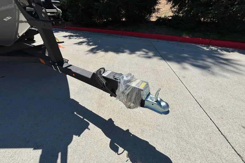 Slide: The Image of Trailer hitch of 2027 Tracker Super Guide V-16 SC on concrete surface. - 34