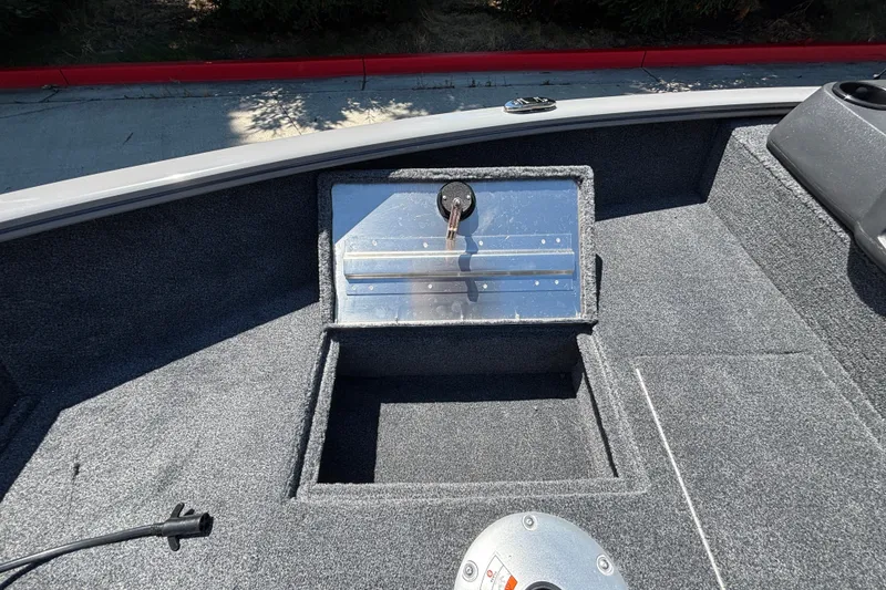Slide: The Image of Interior of 2027 Tracker Super Guide V-16 SC boat with open storage compartment. - 26