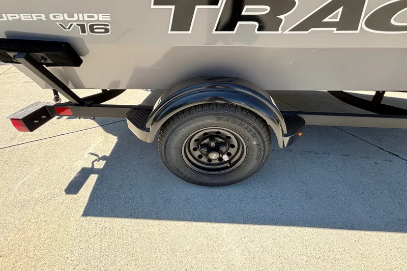 Slide: The Image of Trailer wheel of 2027 Tracker Super Guide V-16 SC on concrete surface. - 33