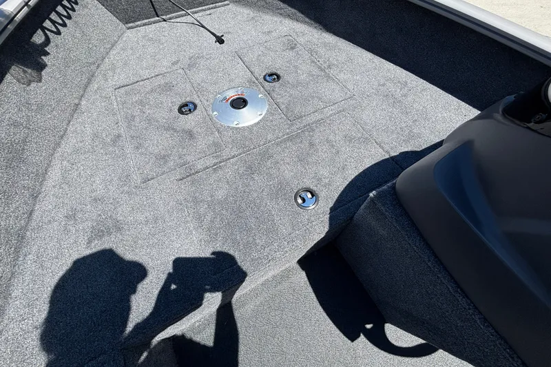 Slide: The Image of Interior of 2027 Tracker Super Guide V-16 SC boat with carpeted flooring and storage compartments. - 31