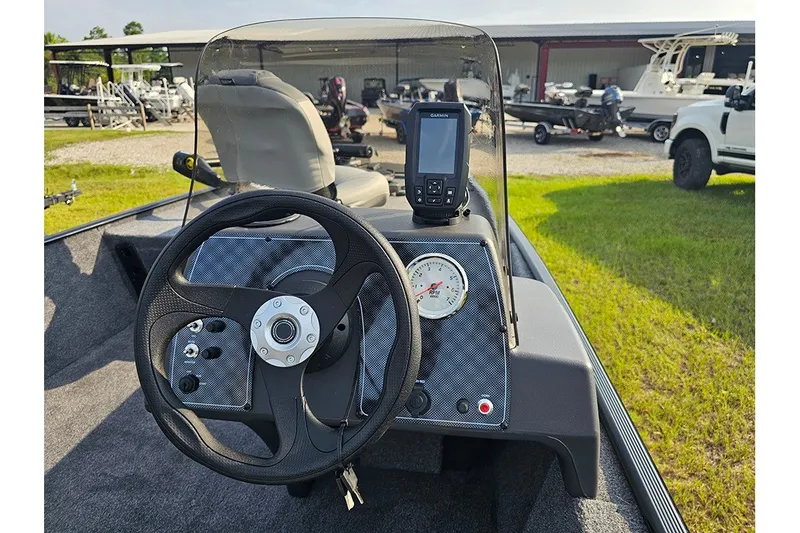 Slide: The Image of 2027 Tracker Bass Tracker Classic XL boat dashboard with steering wheel and navigation system. - 17