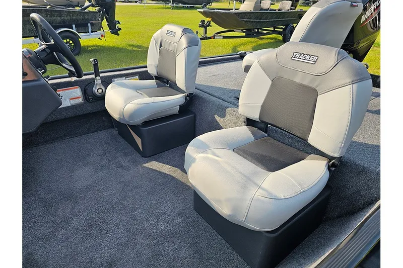 Slide: The Image of 2027 Tracker Bass Tracker Classic XL boat interior with gray seating and steering wheel. - 14