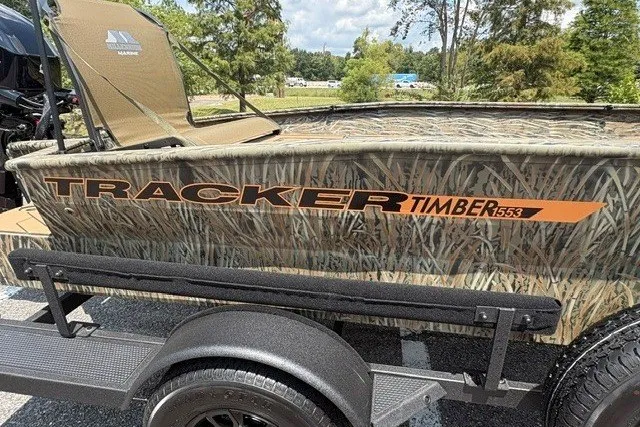 Slide: The Image of 2027 Tracker Grizzly 1553 Timber boat with camouflage design on a trailer. - 13