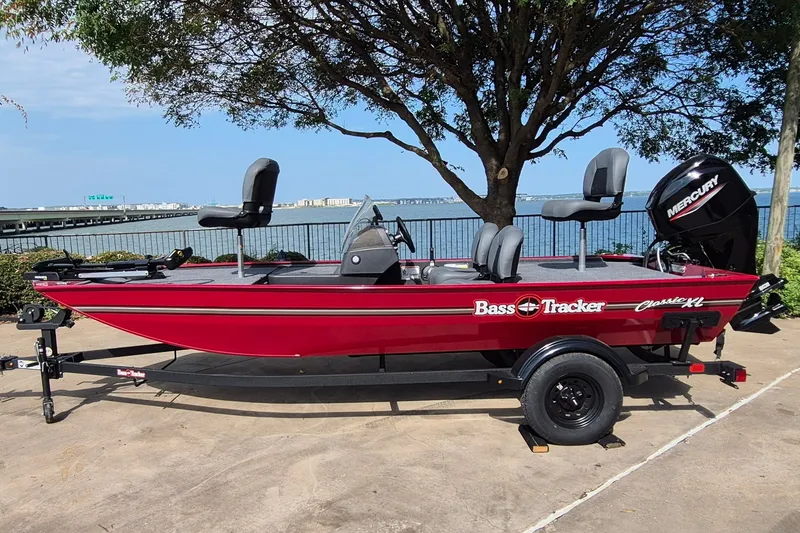 The Image of 2027 Tracker Bass Tracker Classic XL boat on trailer by waterfront. - 0