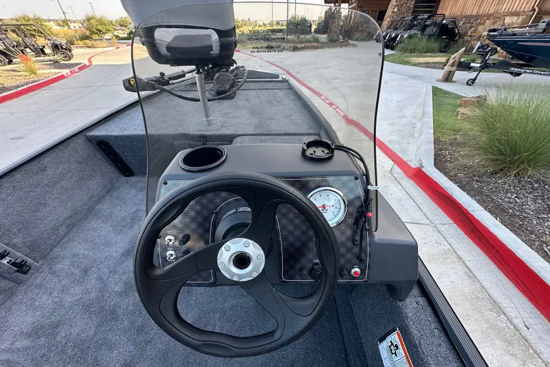 Slide: The Image of 2027 Tracker Bass Tracker Classic XL boat dashboard with steering wheel and gauge. - 65