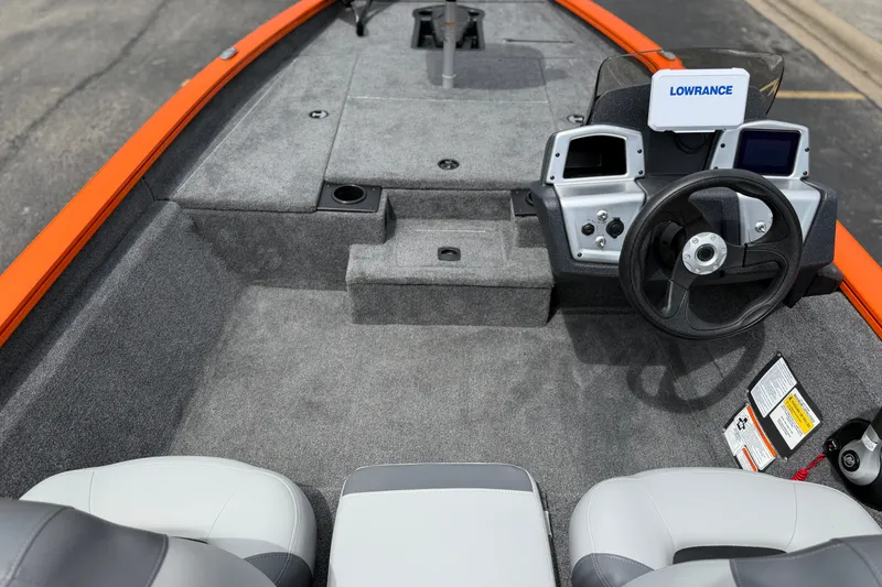 Slide: The Image of Interior of 2027 Tracker Pro Team 175 boat with steering wheel and navigation system. - 13