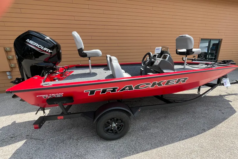 The Image of 2027 Tracker Pro Team 175 boat with Mercury engine, red exterior, parked outdoors. - 0