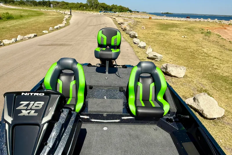 Slide: The Image of 2027 Nitro Z18 XL Pro boat with green seats on a lakeside road. - 17