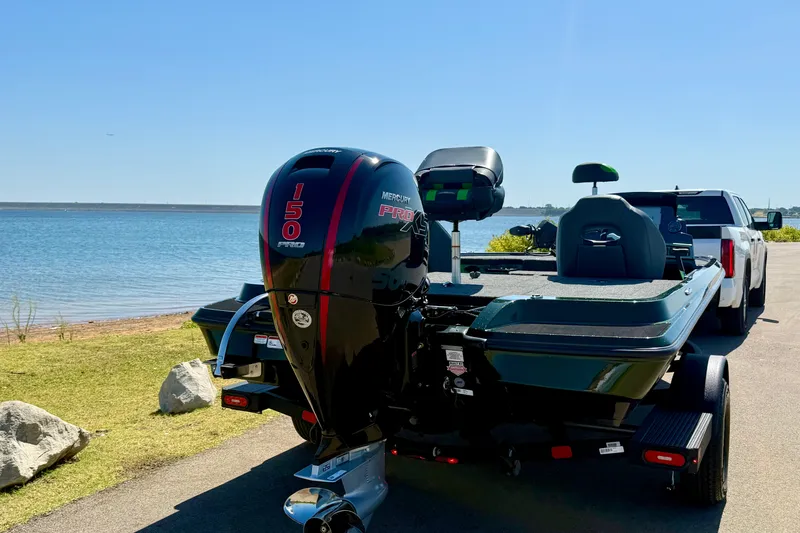 Slide: The Image of 2027 Nitro Z18 XL Pro boat with Mercury 150 Pro XS engine by a lake. - 12