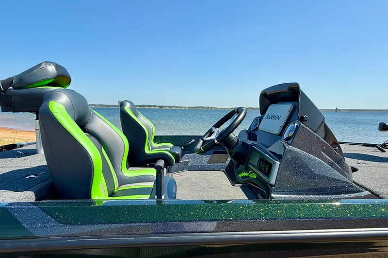 Slide: The Image of 2027 Nitro Z18 XL Pro boat interior with green-accented seats and Garmin navigation system. - 8