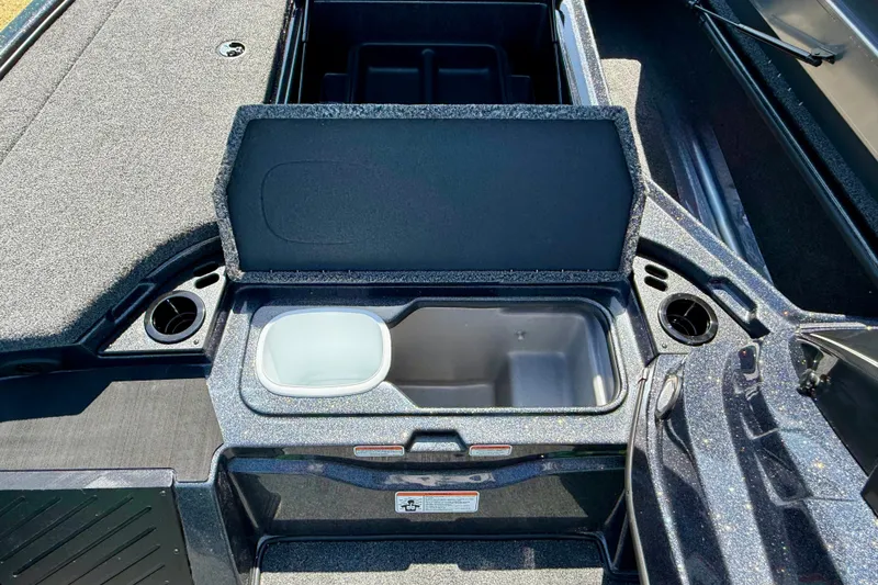 Slide: The Image of 2027 Nitro Z18 XL Pro boat storage compartment with open lid and cup holders. - 16