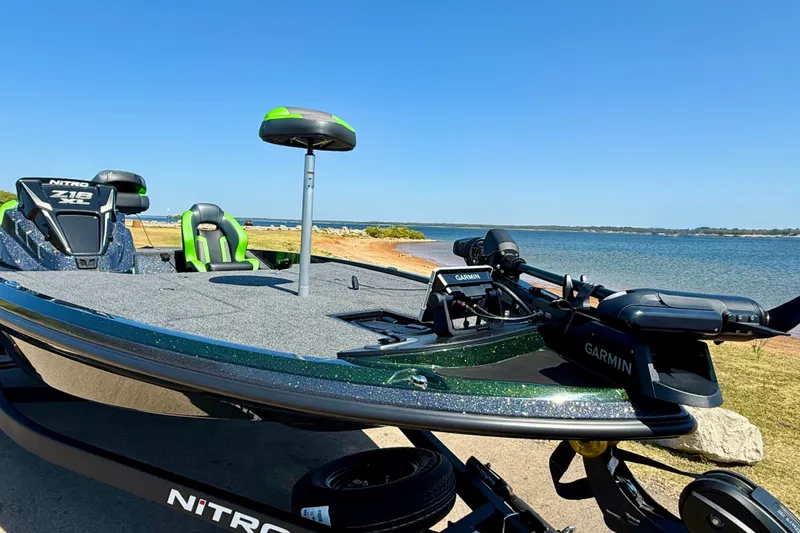 Slide: The Image of 2027 Nitro Z18 XL Pro fishing boat by the lake with Garmin equipment. - 7