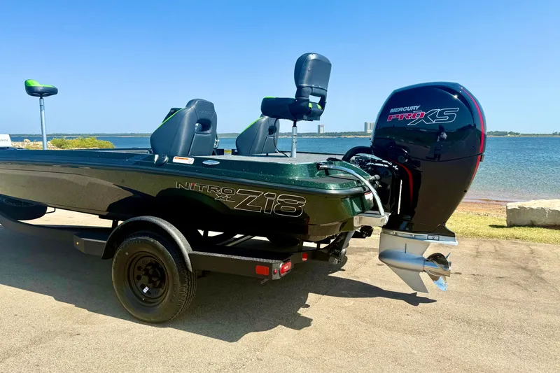 Slide: The Image of 2027 Nitro Z18 XL Pro boat with Mercury Pro XS engine by the water. - 3