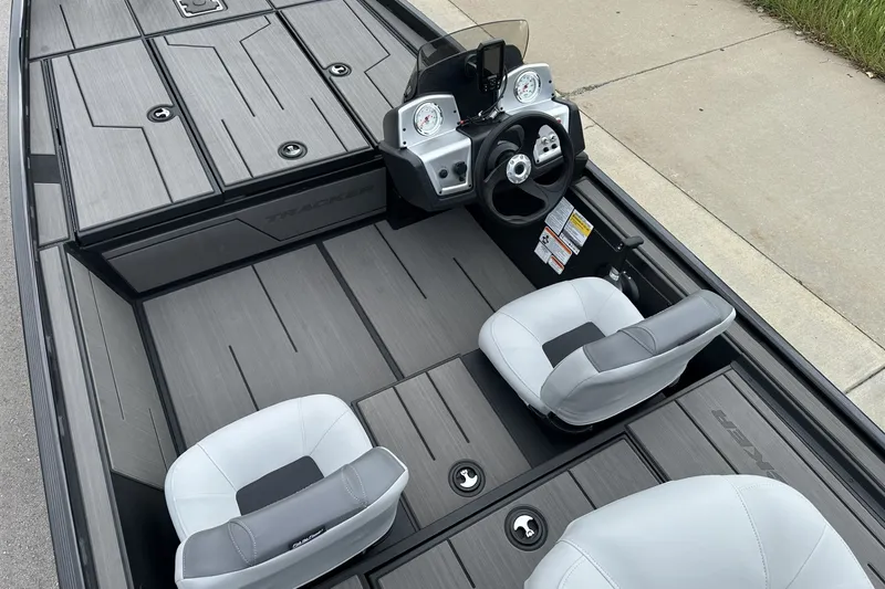 Slide: The Image of 2027 Tracker Pro 170 boat interior with steering wheel and seating, featuring sleek design. - 24