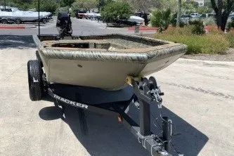 The Image of 2027 Tracker Grizzly 1553 Timber boat on trailer in outdoor setting. - 0