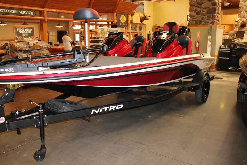 Slide: The Image of 2027 Nitro Z18 XL boat displayed indoors with red and white design. - 1
