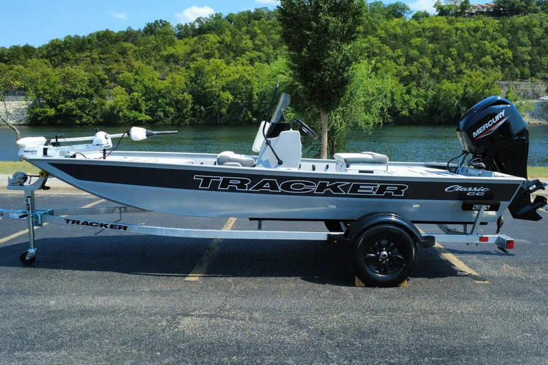 The Image of 2027 Tracker Bass Tracker Classic CC boat on trailer by a scenic river. - 0