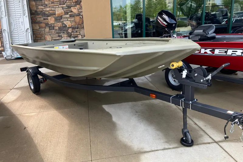 The Image of 2027 Tracker Grizzly 1648 Utility boat on trailer, displayed outdoors. - 0