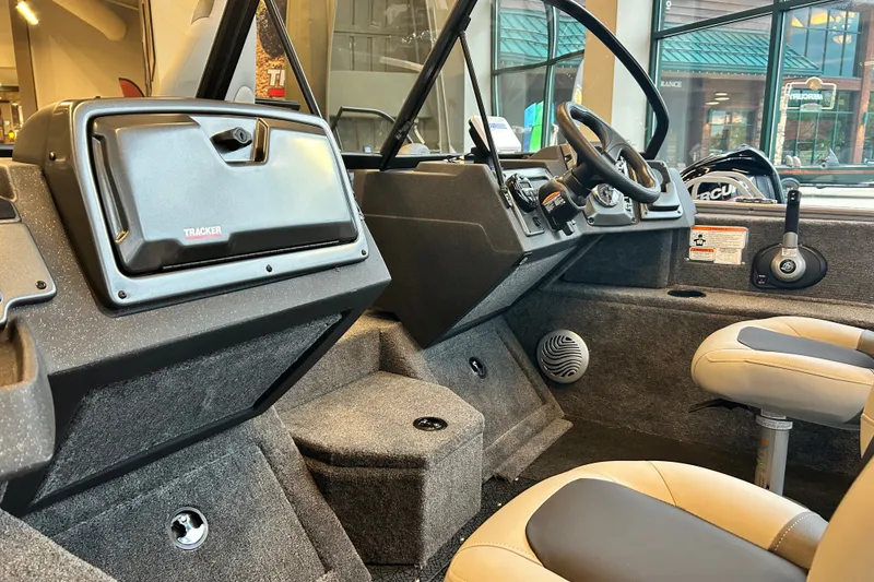 Slide: The Image of Interior of 2027 Tracker Pro Guide V-175 Combo boat, featuring steering console and seating. - 53