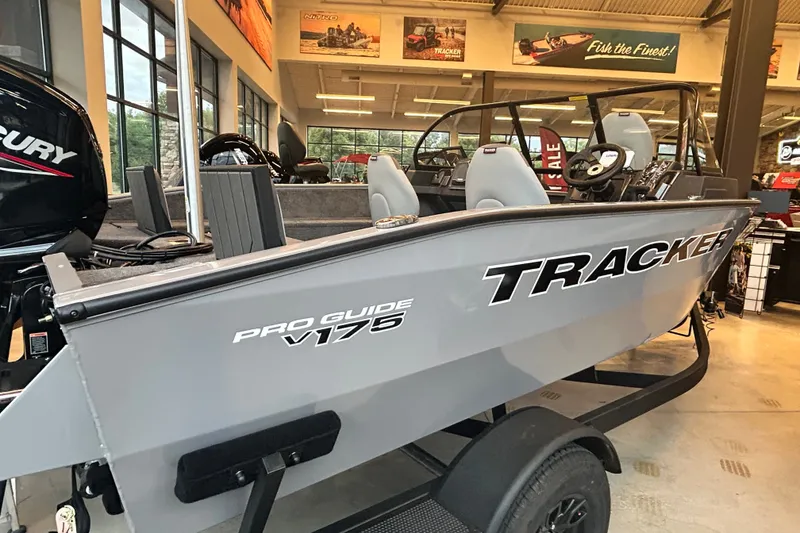 Slide: The Image of 2027 Tracker Pro Guide V-175 Combo boat displayed in showroom, featuring sleek design and modern features. - 13
