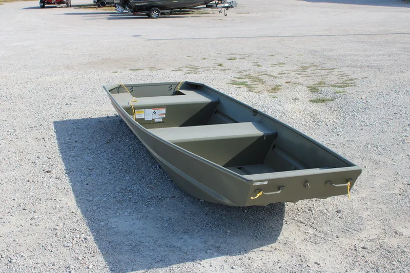 The Image of 2027 Tracker Grizzly 14 Jon boat on gravel surface, showcasing its sturdy design. - 0