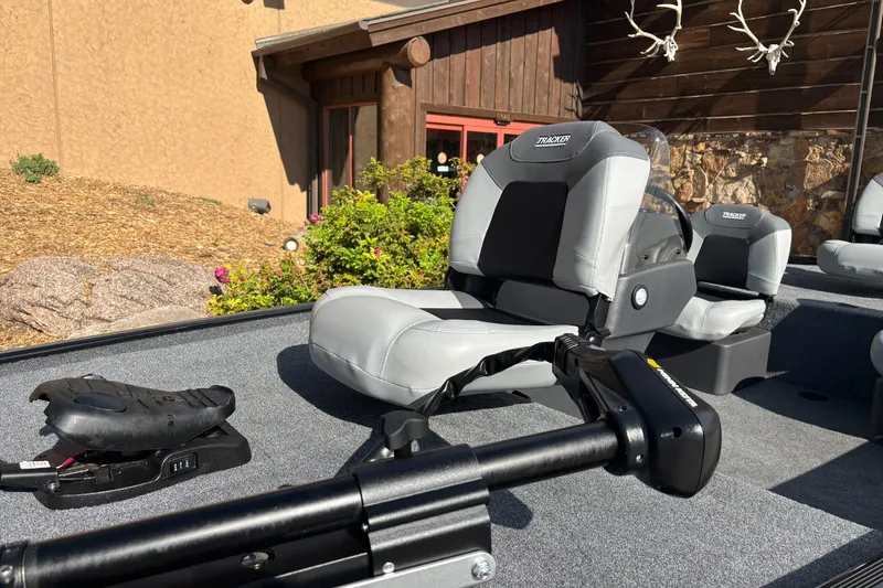 Slide: The Image of 2027 Tracker Bass Tracker Classic XL boat interior with gray seating and trolling motor. - 13